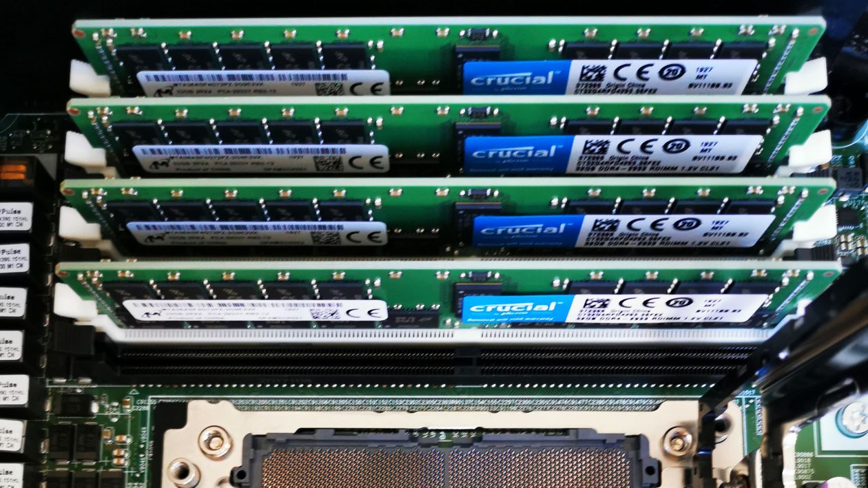 Rows of memory modules installed above an empty processor socket on a server board.