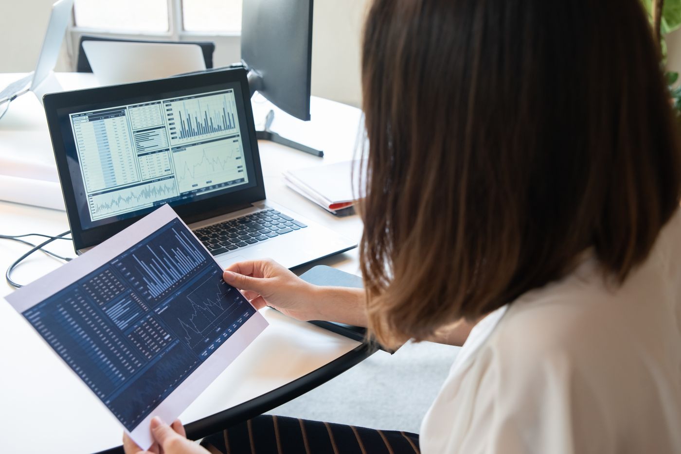 An Oklahoma Data Partners analyst reviewing a Power BI report with a client